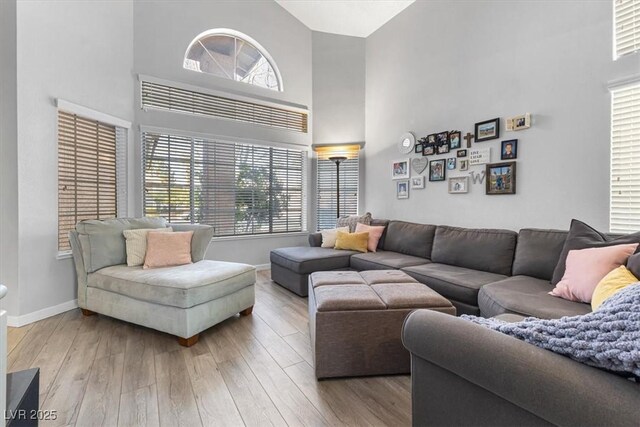 8433 Honeywood Cir, Las Vegas, NV 89128 - living room with a high ceiling, wood finished floors, and plenty of natural light