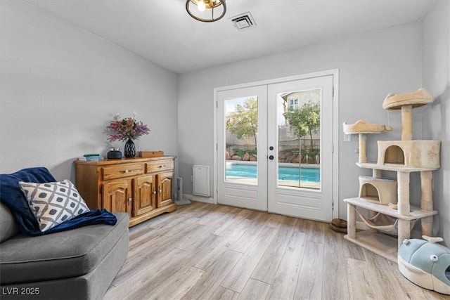 8433 Honeywood Cir, Las Vegas, NV 89128 - living area with light wood-style floors and french doors