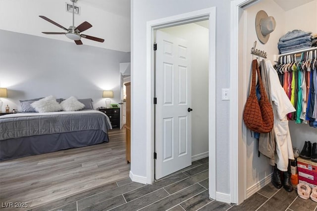 8433 Honeywood Cir, Las Vegas, NV 89128 - bedroom with dark wood-style flooring, lofted ceiling, baseboards, ceiling fan, and a closet