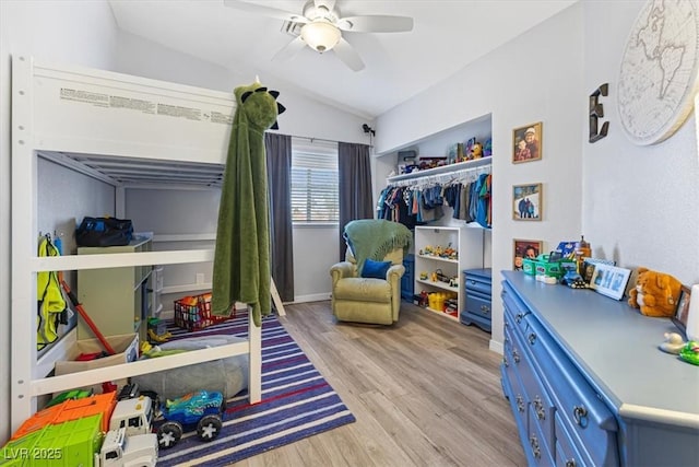 8433 Honeywood Cir, Las Vegas, NV 89128 - bedroom featuring lofted ceiling, light wood-style floors, a closet, a ceiling fan, and baseboards