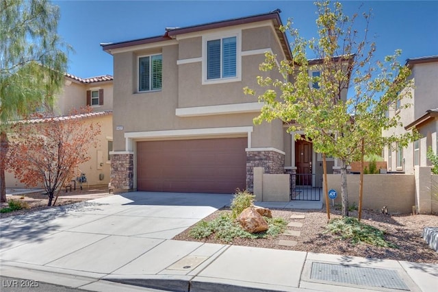 view of front facade featuring fence, driveway, an attached garage, stucco siding, and stone siding