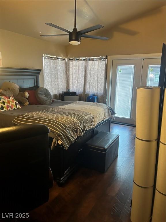 bedroom featuring ceiling fan and dark wood-style flooring