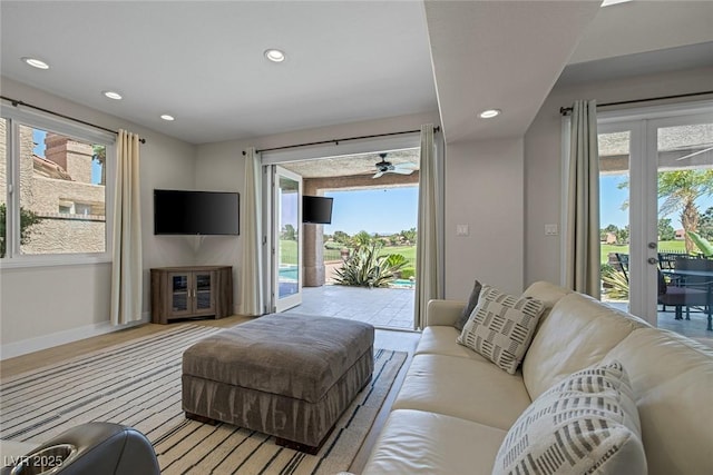 living area featuring recessed lighting, french doors, a ceiling fan, and baseboards