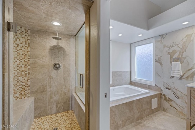 full bathroom featuring vanity, a garden tub, recessed lighting, and a stall shower