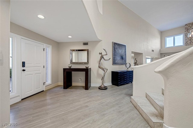 foyer with recessed lighting, visible vents, baseboards, and light wood finished floors