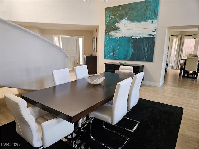 dining area featuring wood finished floors and baseboards