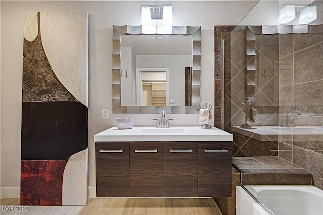 bathroom with vanity, wood finished floors, and shower / bathtub combination