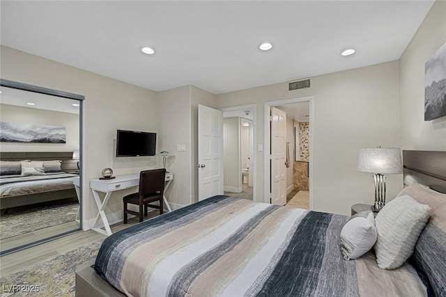 bedroom with visible vents, baseboards, ensuite bath, recessed lighting, and light wood-style floors