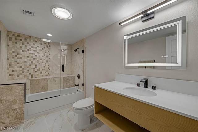 bathroom with visible vents, toilet, combined bath / shower with glass door, marble finish floor, and vanity