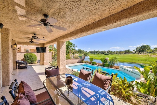 view of patio / terrace featuring an outdoor pool, a fenced backyard, outdoor dining space, and a ceiling fan