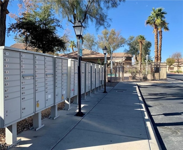 view of home's community featuring mail area and fence