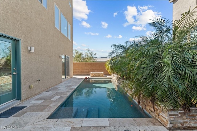 view of swimming pool featuring a patio and fence