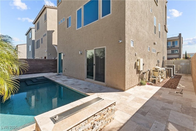 view of pool with a patio area, cooling unit, and a fenced backyard