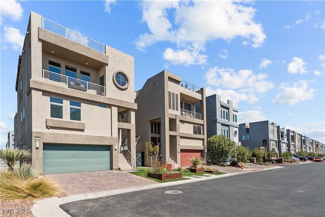 view of building exterior with driveway and an attached garage