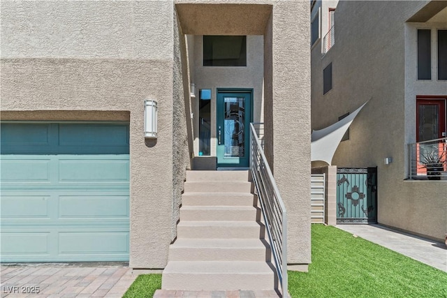 doorway to property with stucco siding and a garage