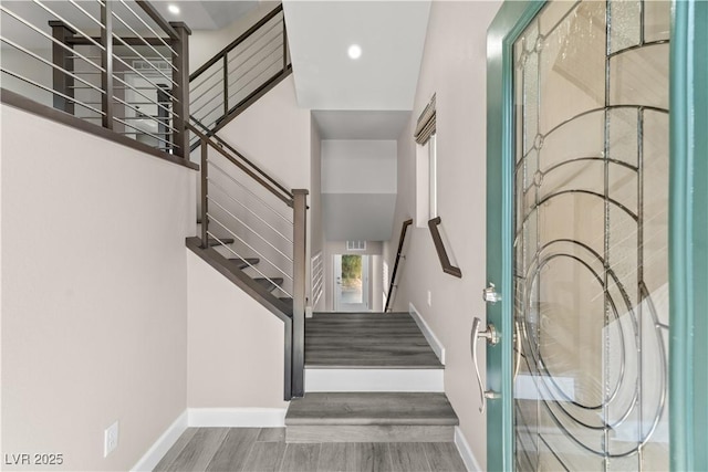 stairs featuring visible vents, recessed lighting, baseboards, and wood finished floors