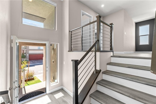 foyer with stairs and baseboards