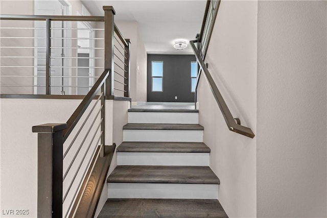 staircase featuring wood finished floors