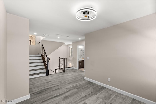 interior space featuring visible vents, wood finished floors, recessed lighting, baseboards, and stairs