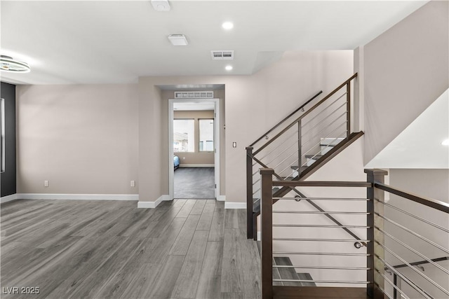 foyer featuring recessed lighting, visible vents, baseboards, and wood finished floors