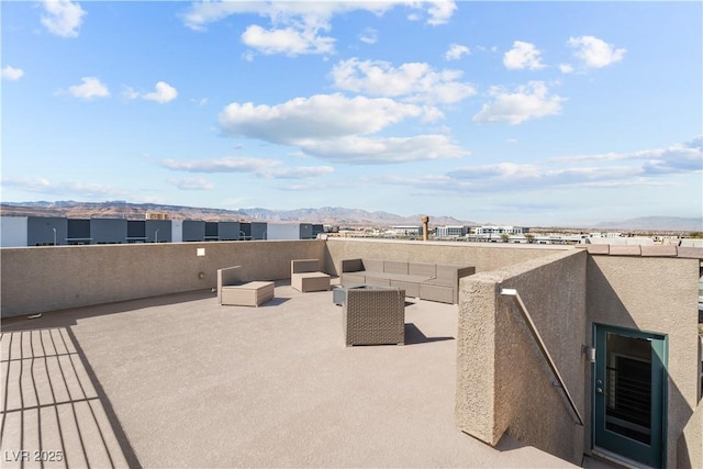 view of patio featuring an outdoor living space and a mountain view