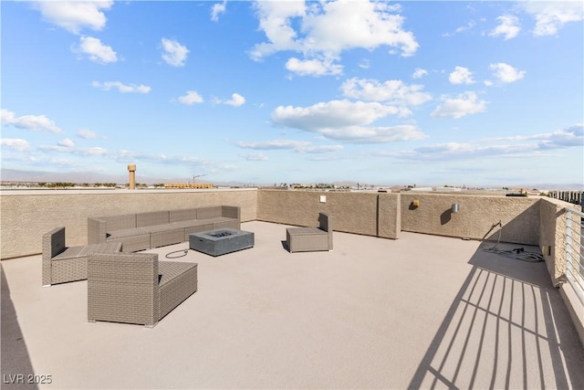 view of patio featuring an outdoor living space with a fire pit