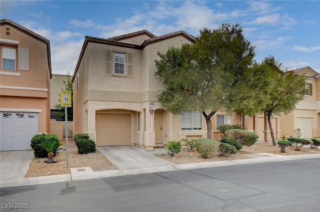 view of front of property featuring stucco siding, an attached garage, and concrete driveway