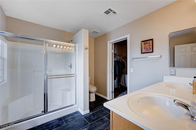 bathroom with a sink, visible vents, a stall shower, and tile patterned flooring