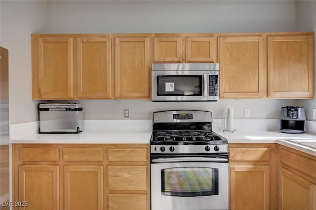11092 Abbeyfield Rose Dr, Henderson, NV 89052 - kitchen featuring light brown cabinets, light countertops, and appliances with stainless steel finishes
