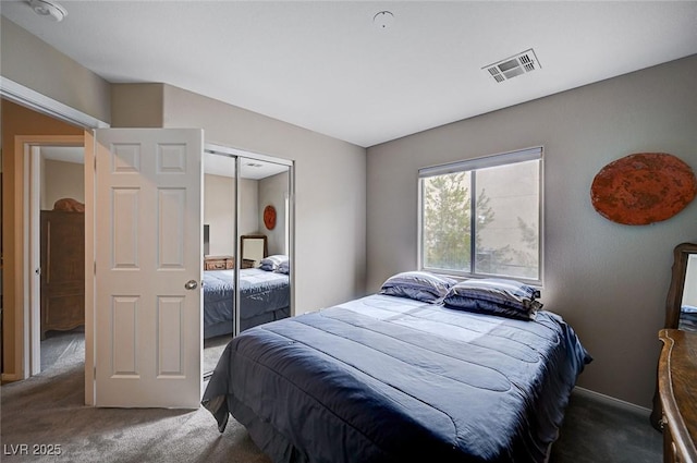 carpeted bedroom featuring visible vents and a closet