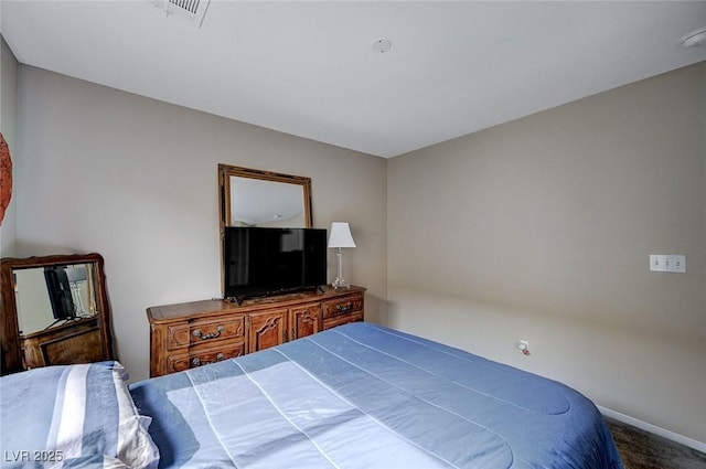 carpeted bedroom with visible vents and baseboards