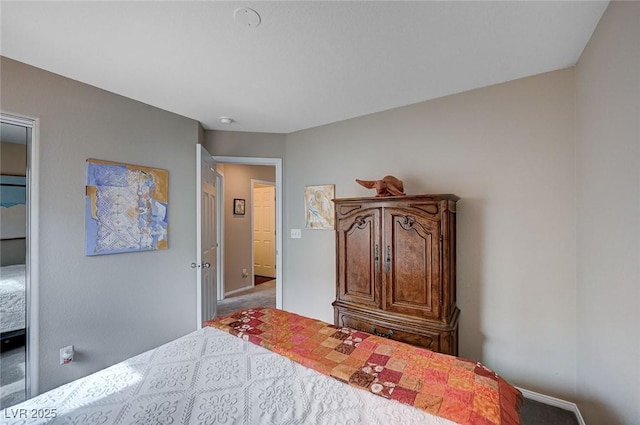 carpeted bedroom featuring baseboards