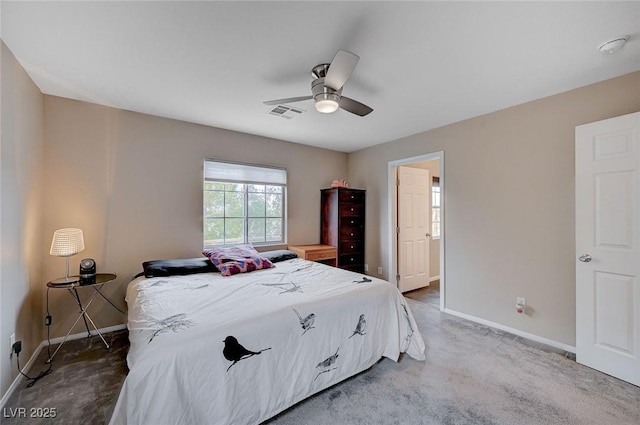 bedroom featuring ceiling fan, visible vents, baseboards, and light carpet