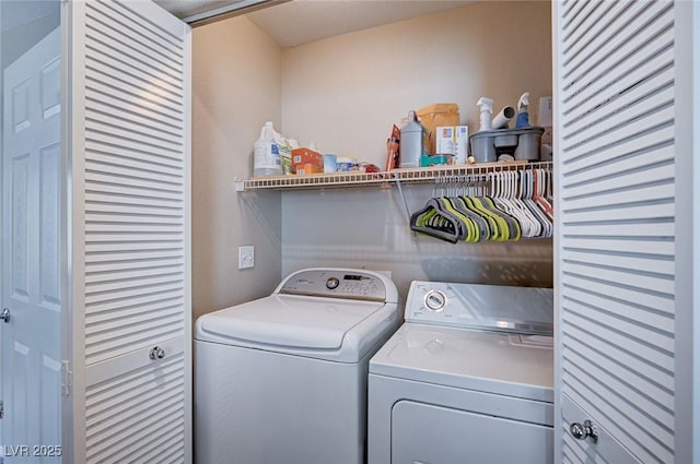 washroom with washing machine and clothes dryer and laundry area