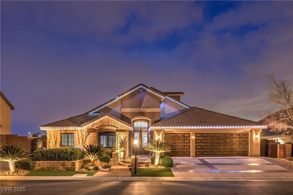 4752 Rancho Camino Ct, Las Vegas, NV 89129 - mediterranean / spanish home with stucco siding, fence, an attached garage, a tiled roof, and driveway