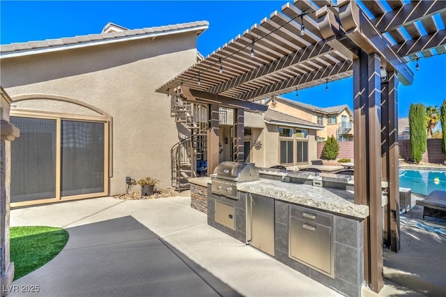 view of patio with grilling area, fence, exterior kitchen, and a pergola