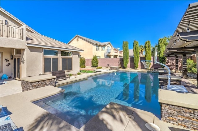 view of swimming pool featuring a patio area, a fenced backyard, and a fenced in pool