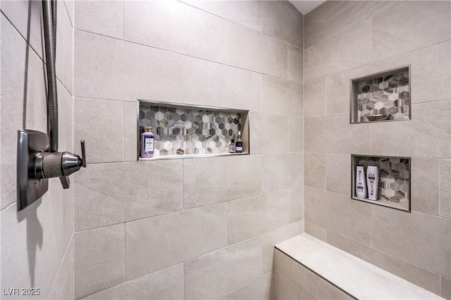 bathroom with a tile shower