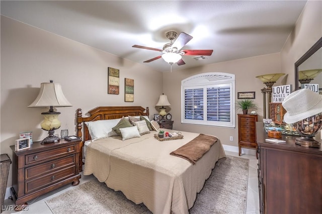 bedroom with ceiling fan, visible vents, and light tile patterned flooring