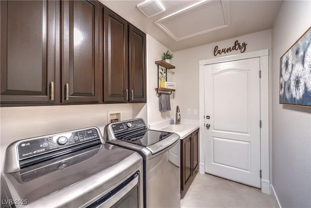 clothes washing area featuring visible vents, baseboards, washing machine and dryer, light tile patterned floors, and cabinet space