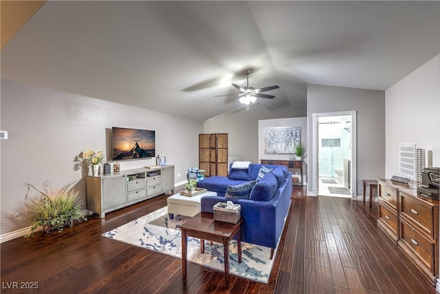 living area with dark wood finished floors, baseboards, a ceiling fan, and vaulted ceiling