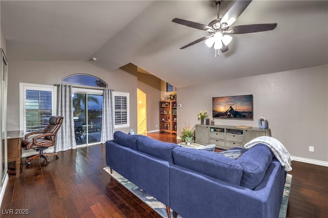 living area featuring baseboards, wood-type flooring, ceiling fan, and vaulted ceiling