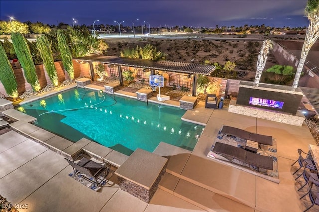 pool at night featuring a pergola, fence, a patio area, and a fenced in pool