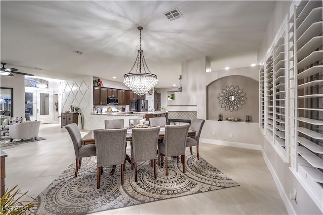 dining area featuring visible vents, ceiling fan with notable chandelier, recessed lighting, arched walkways, and baseboards