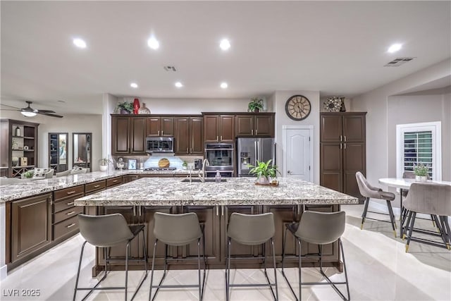 kitchen featuring a large island, visible vents, appliances with stainless steel finishes, and a sink