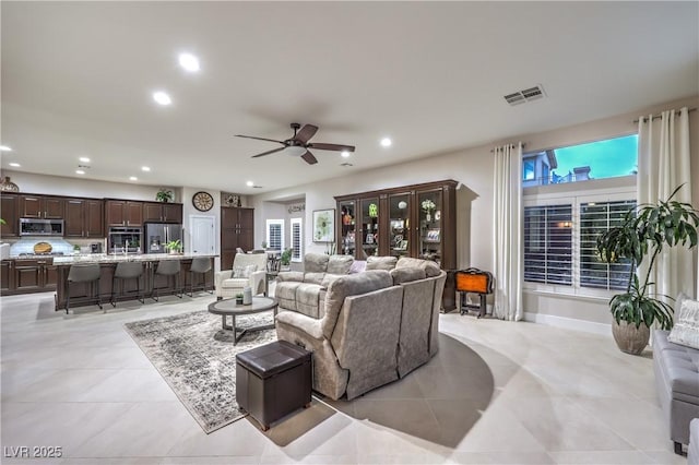 living room with visible vents, recessed lighting, light tile patterned flooring, baseboards, and ceiling fan