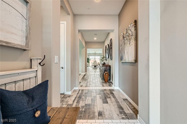 hallway with wood finished floors and baseboards