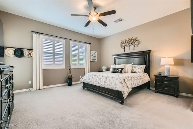 bedroom featuring visible vents, baseboards, light colored carpet, and a ceiling fan