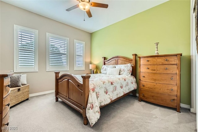 bedroom featuring lofted ceiling, light colored carpet, baseboards, and ceiling fan