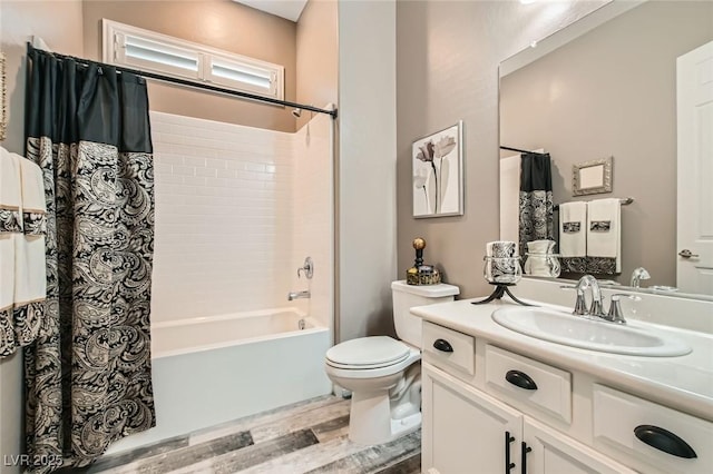 full bath featuring wood finished floors, toilet, vanity, and shower / bathtub combination with curtain